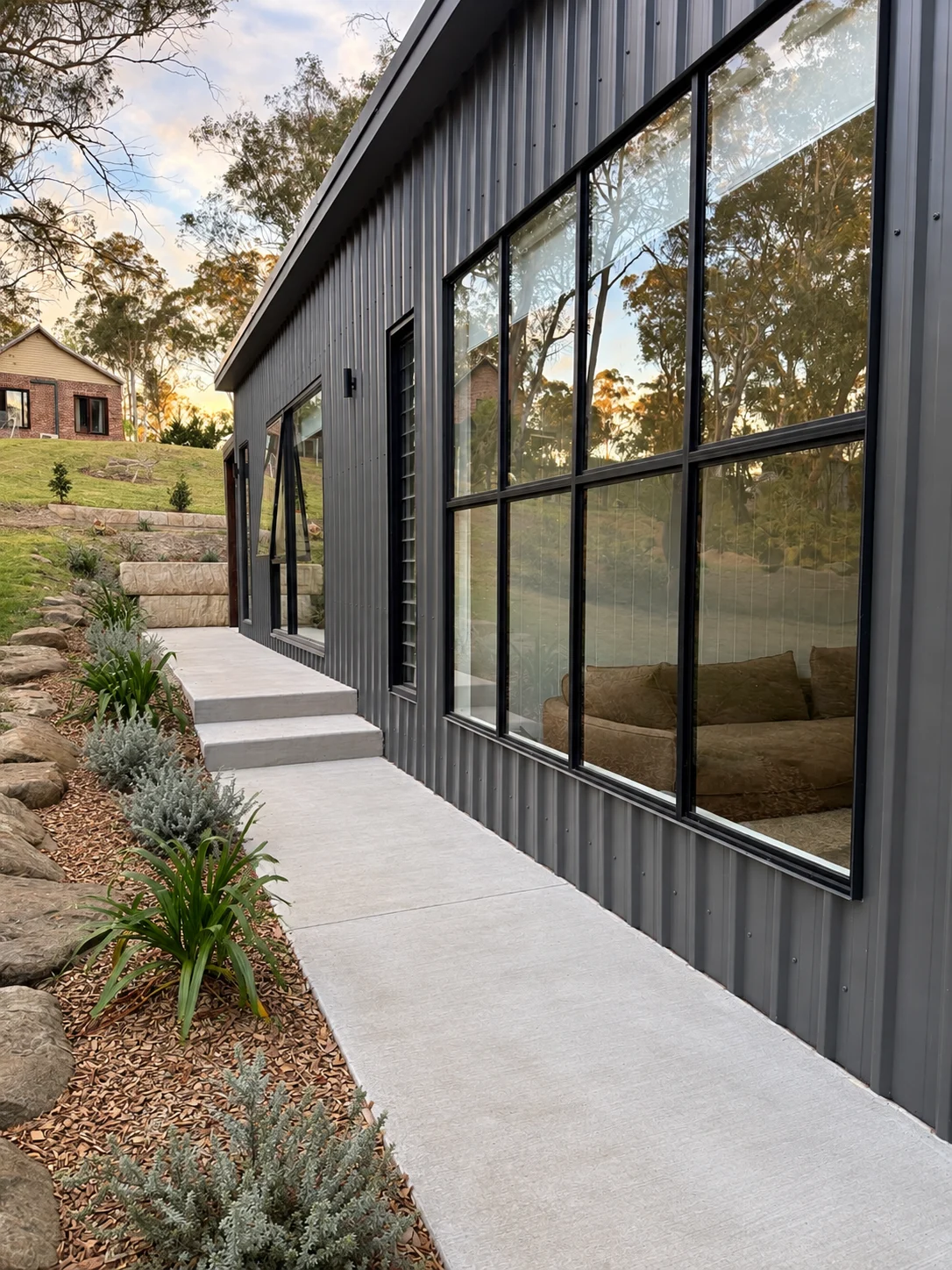 Garden-facing glazing and path beside the garden guest house