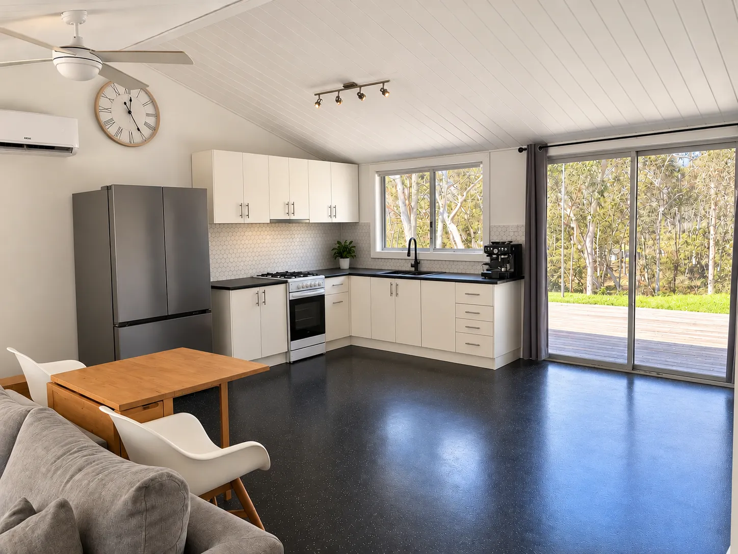 Other guest house kitchen and dining area opening to the deck