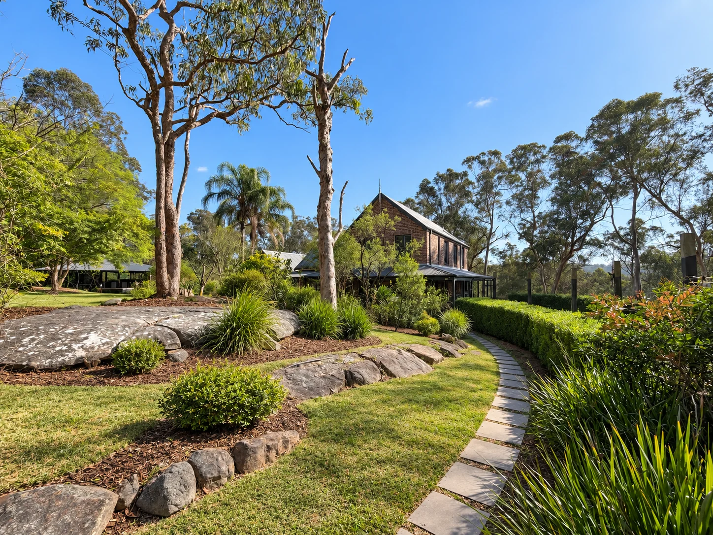 Landscaped paths and garden beds beside the main residence